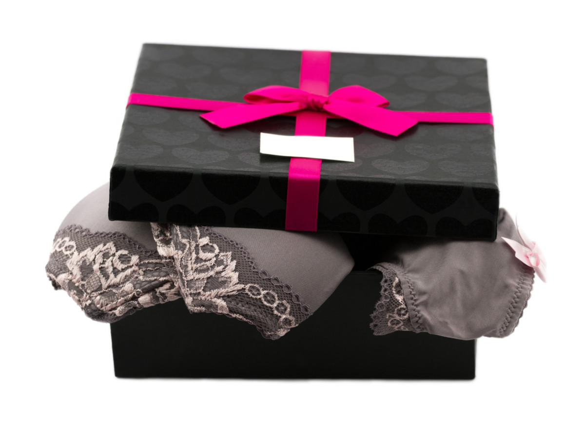 Woman lace lingerie in gift box decorated pink ribbon with bow